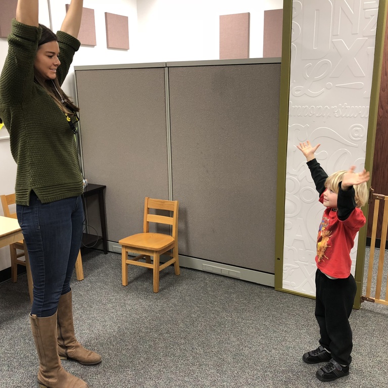 Child and research playing Simon Says game